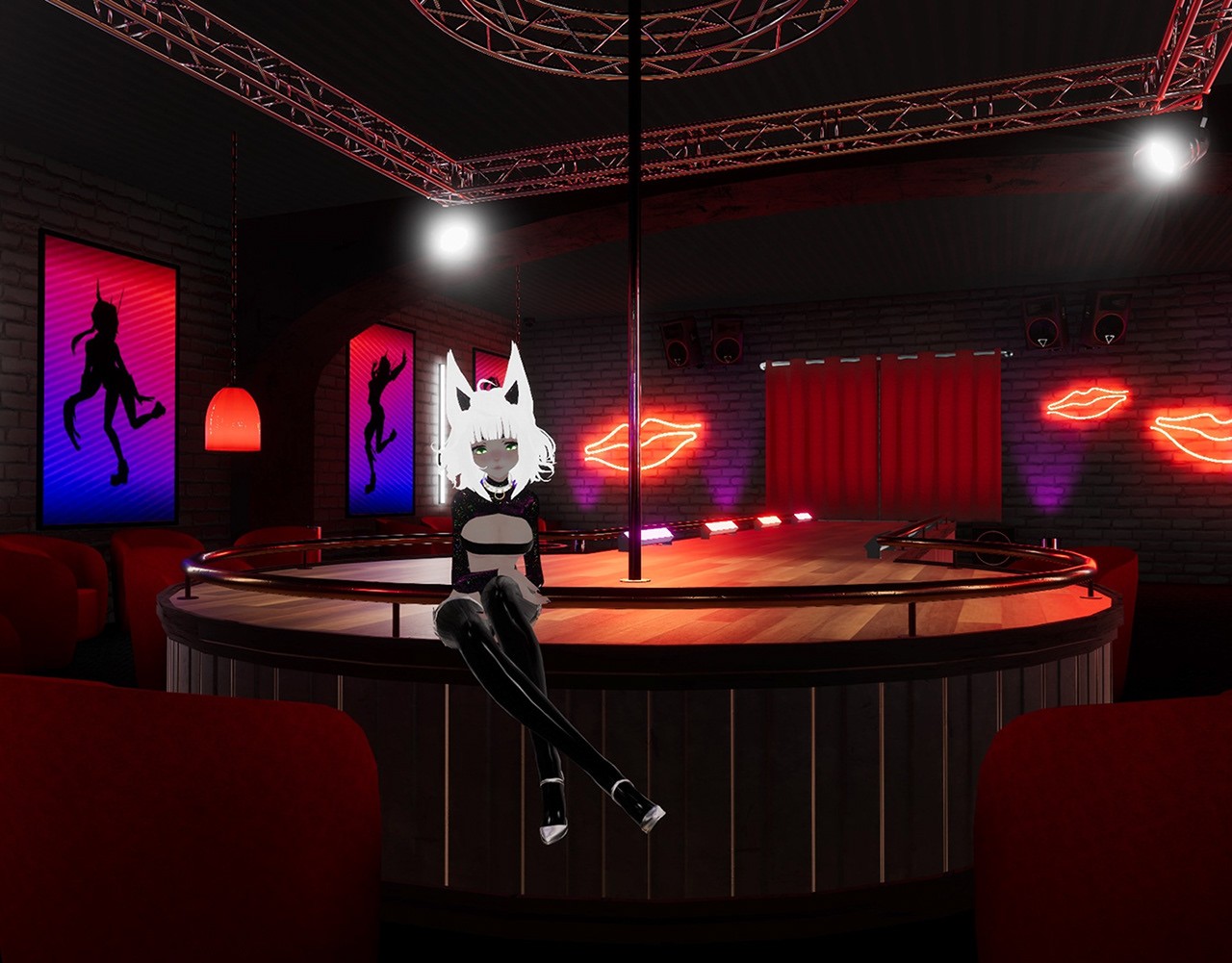 two people sitting on a ledge talking